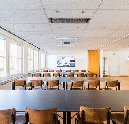 rows of wooden dark tables and chairs