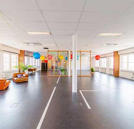 large room with colorful balloons in the back